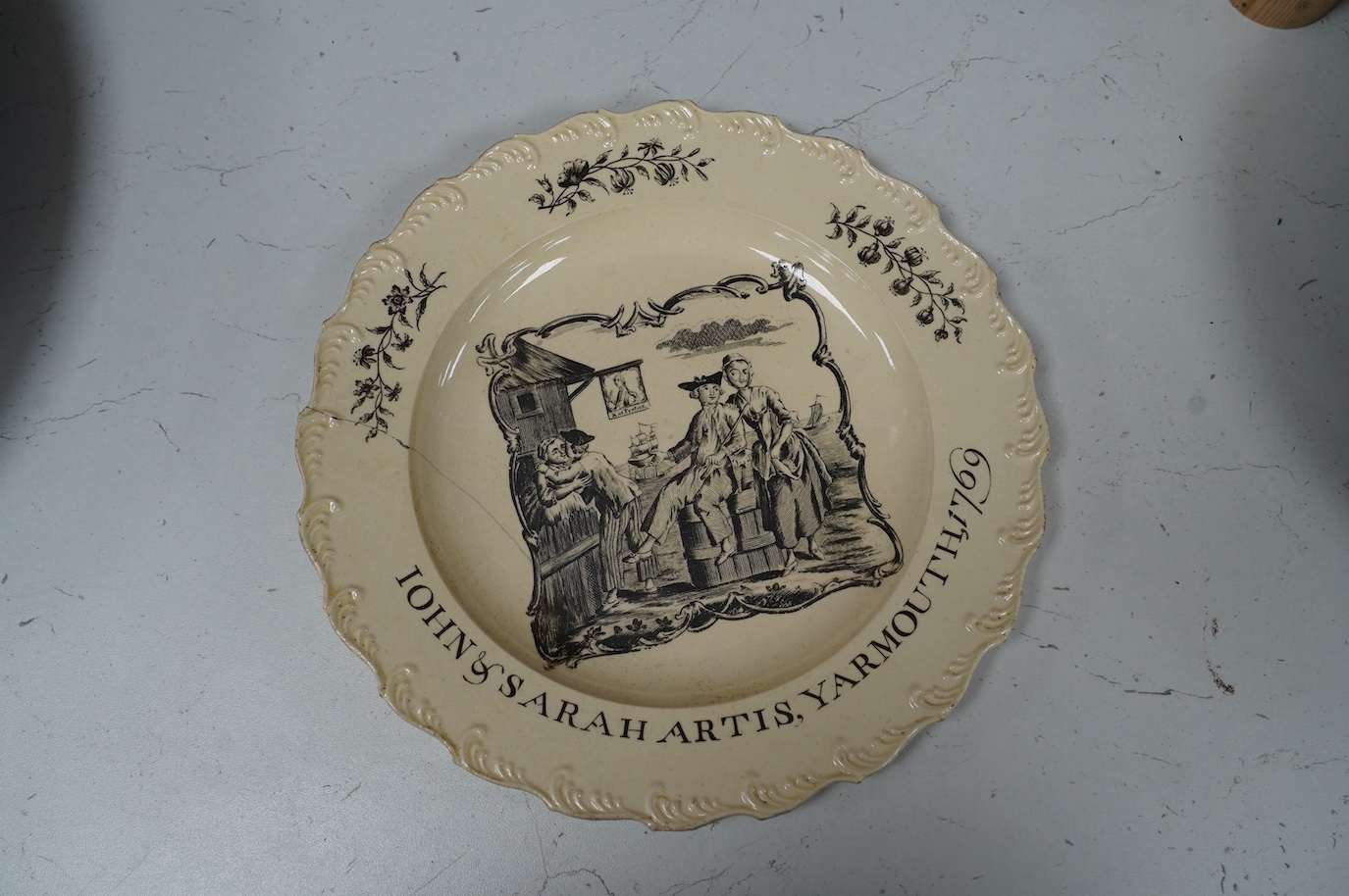 A George III documentary creamware plate, printed by Sadler, black enamelled inscription ‘John and Sarah Artis, Yarmouth 1769’, a further of example in the National Maritime Museum Greenwich (https://www.rmg.co.uk/collec